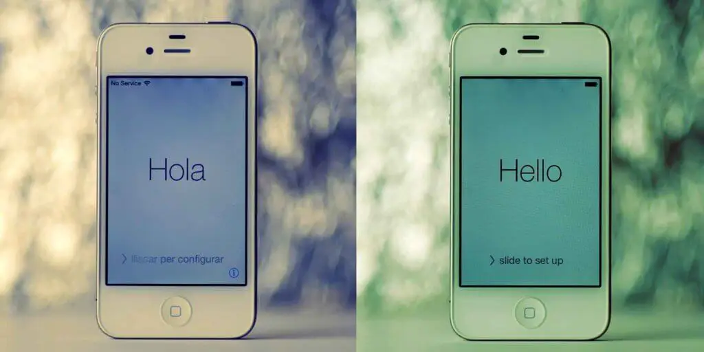 Composite photo of 2 white iPhones in Spanish and English, one that says Hola and one that says Hello.