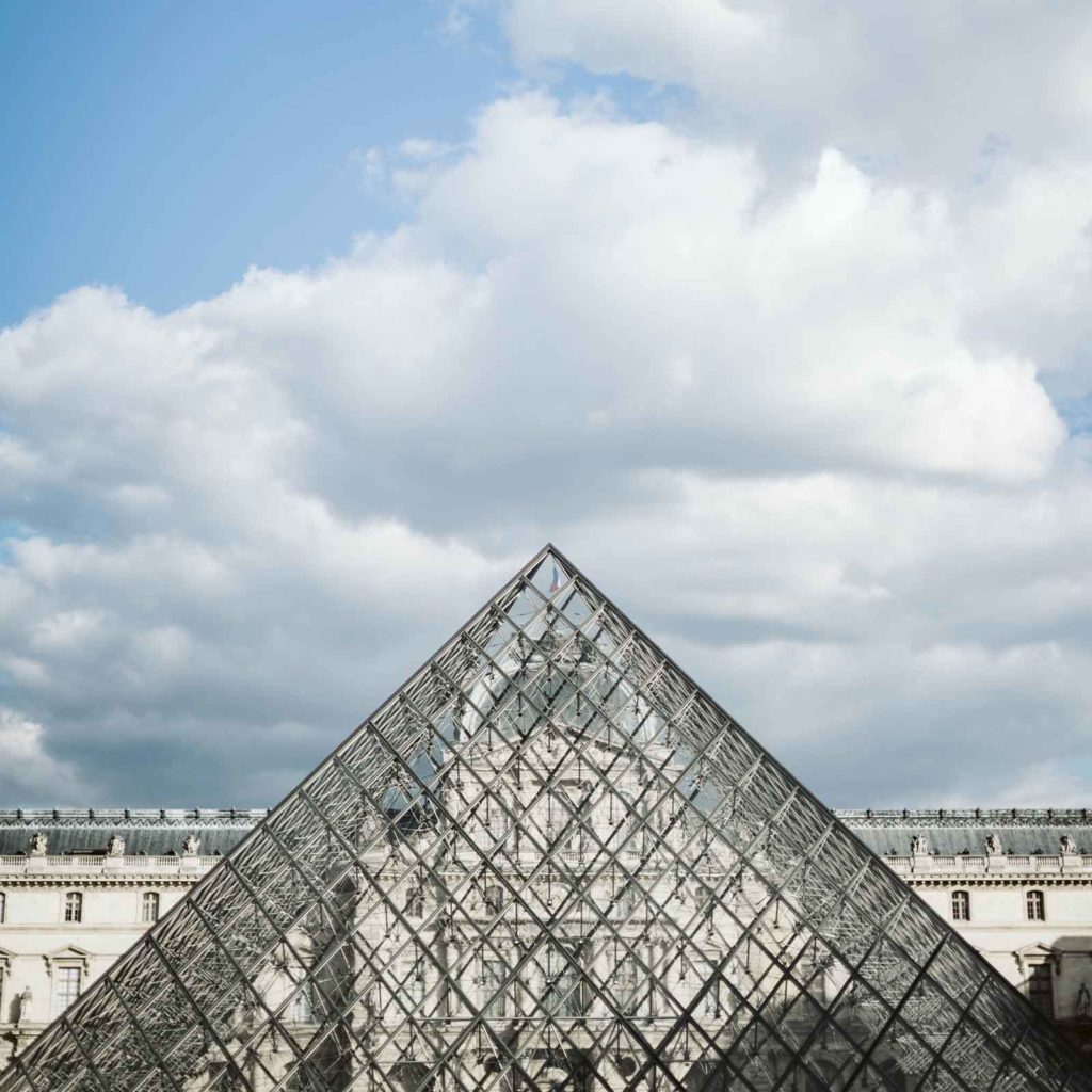 Photo of the glass pyramid outside the Louvre Museum in Paris.