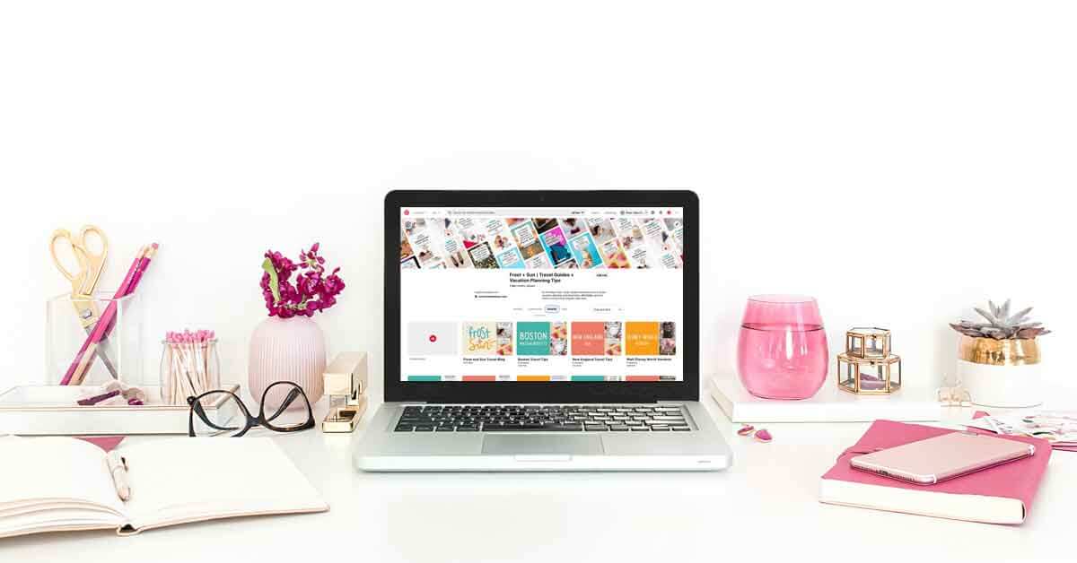 Photo of a desk with rose-colored office accessories and a laptop open to a Pinterest profile.