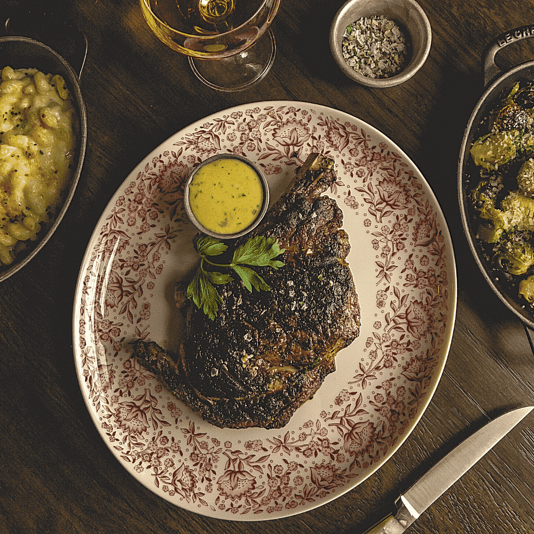 Flatlay of steak and classic sides, plated separately.