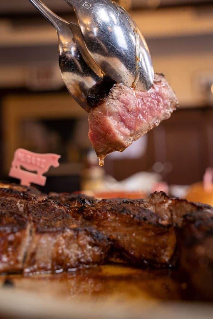 Closeup of a cut of steak cooked rare.