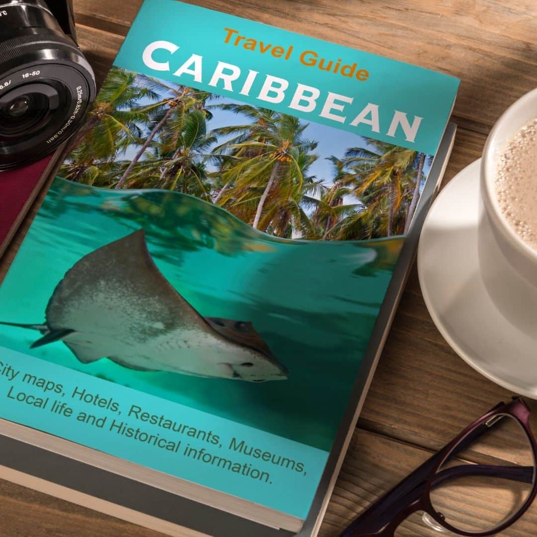 Closeup of a travel guide to the Caribbean on a wooden table.