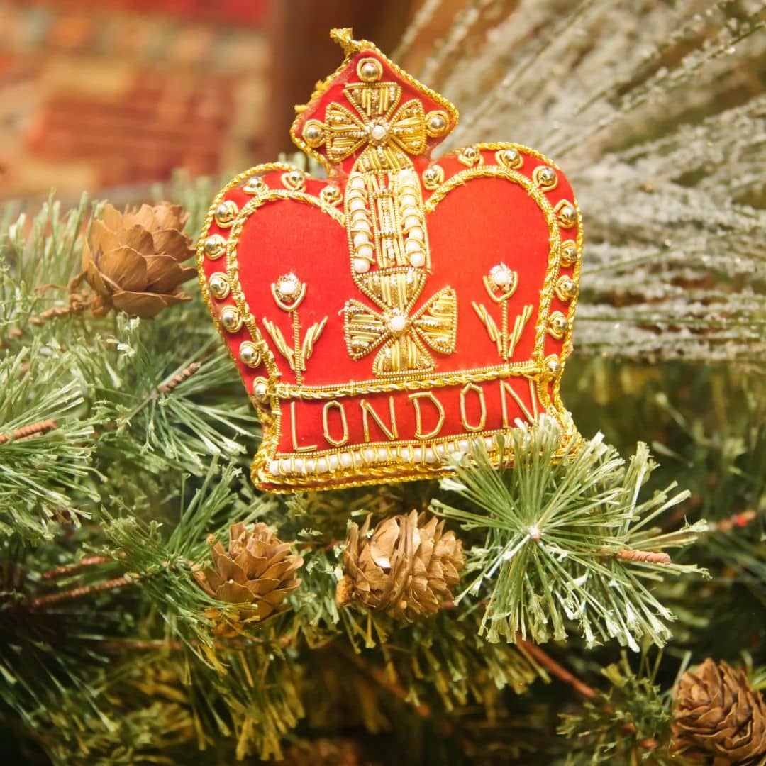 Closeup of a London crown ornament on a Christmas tree.