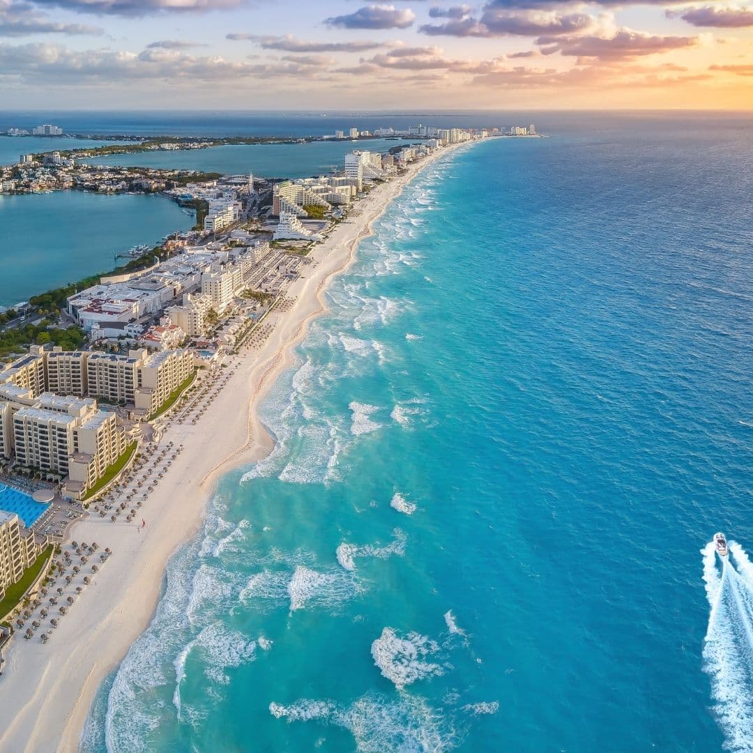 Aerial view of resorts along a beach in Cancun, Mexico.