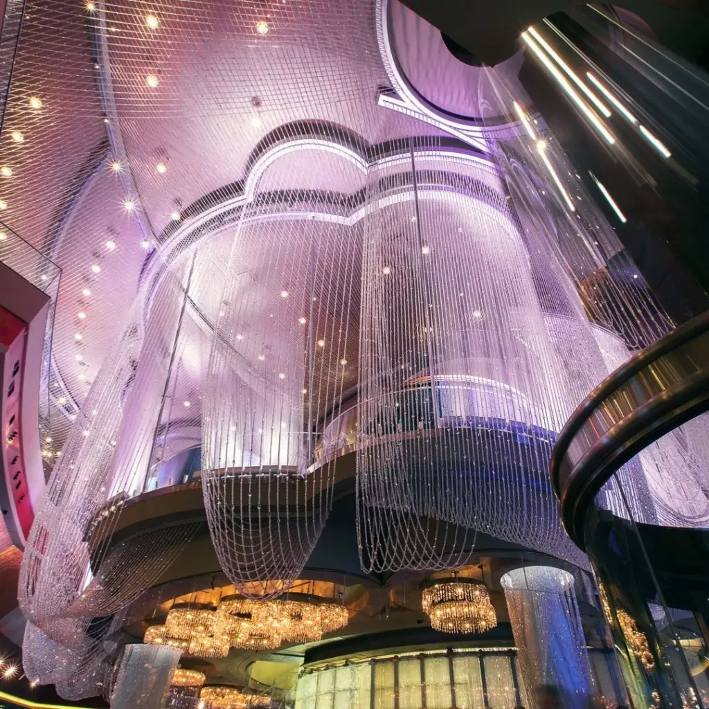 Closeup of the purple-tinged 3 floor chandelier bar at The Cosmopolitan Las Vegas hotel.