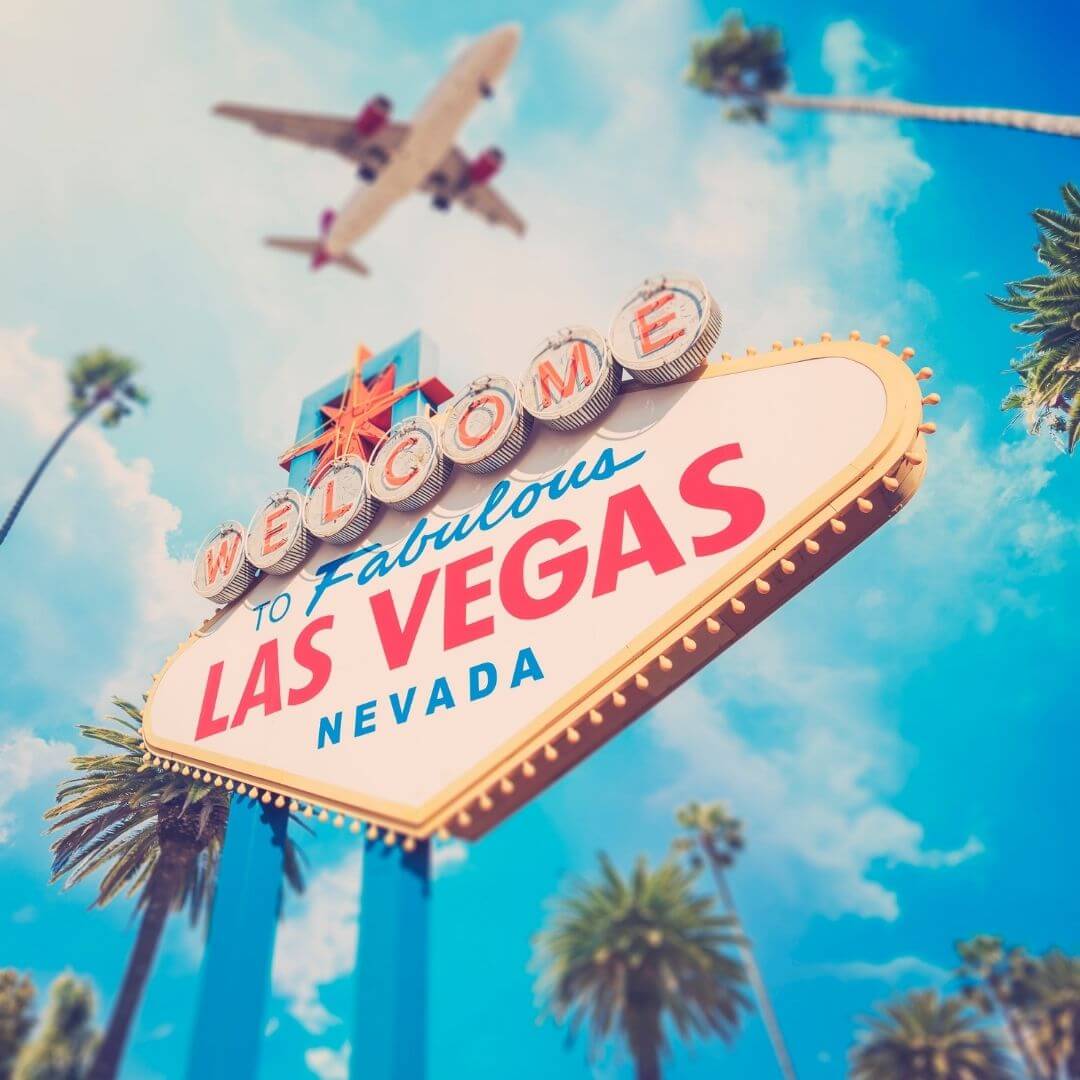 Photo of the iconic Welcome to Fabulous Las Vegas Nevada" sign with a plane flying overhead.