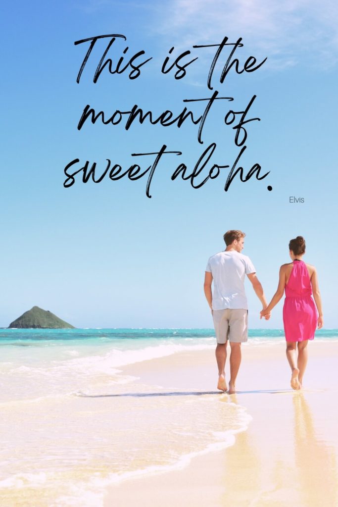 Photo of a man and woman holding hands while walking away from the camera on a beach. Text above the photo reads "This is the moment of sweet aloha. - Elvis"