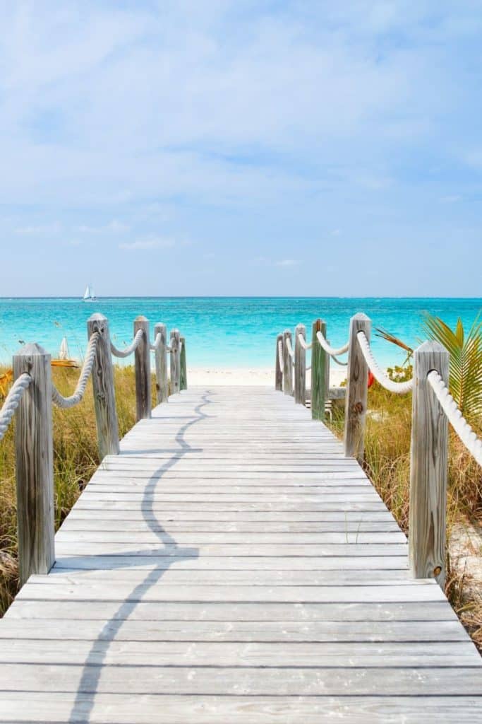 Photo of a wooden walkway leading down to a beach.