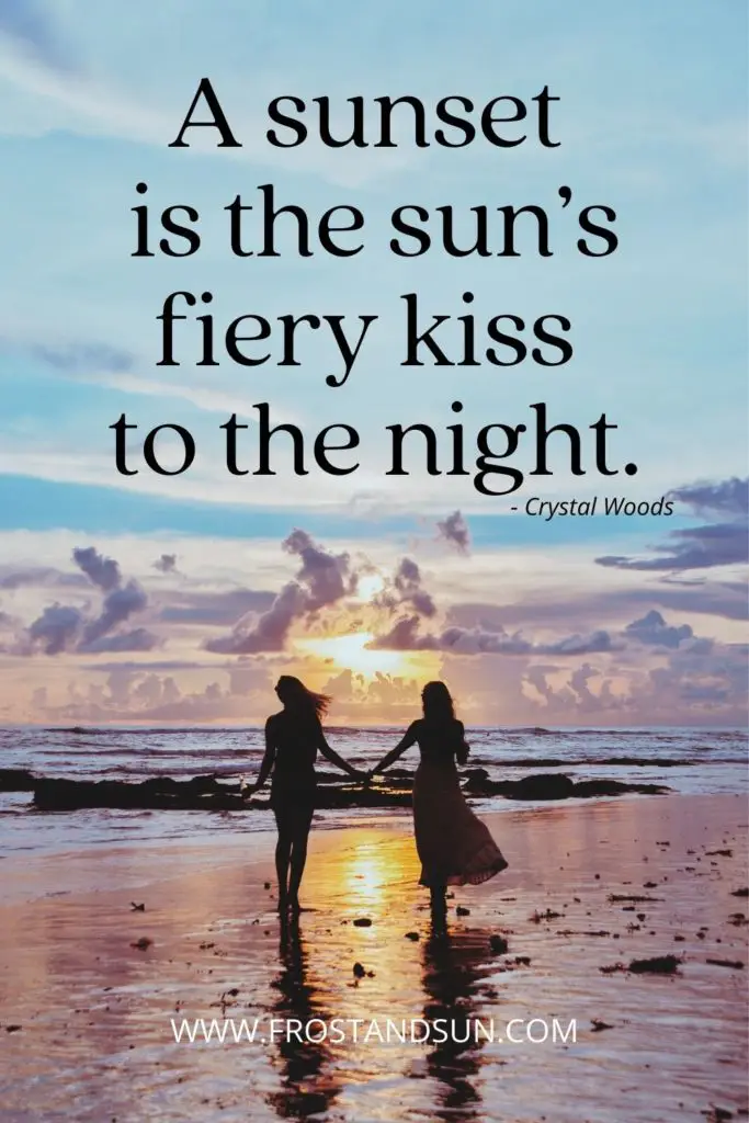 Photo of a couple holding hands while walking along the beach during sunset. Text above them reads "A sunset is the sun's fiery kiss to the night."