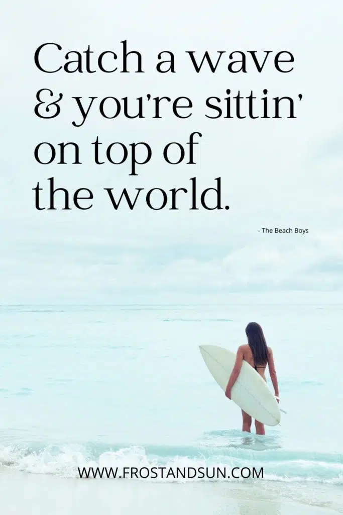 Photo of a woman holding a surfboard while looking out at the ocean in Hawaii.