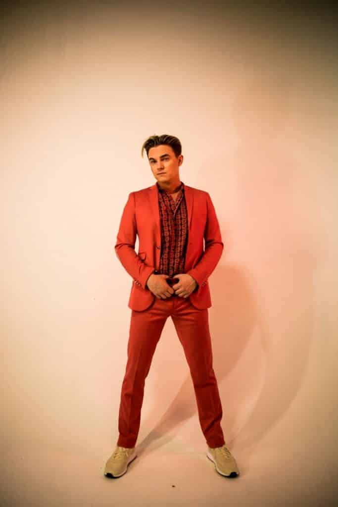 Photo of musician Jess McCartney wearing a red suit.
