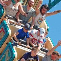 Closeup of people riding a thrill ride at The Big E Midway.