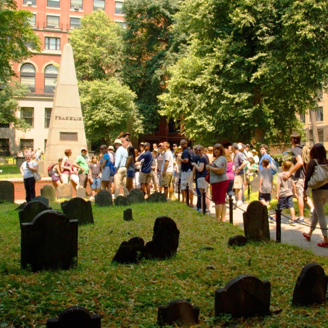 Photo of a group of tourists visiting an old cemetery.