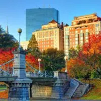 Photo of Boston Public Garden in the Fall with red and orange Fall foliage.
