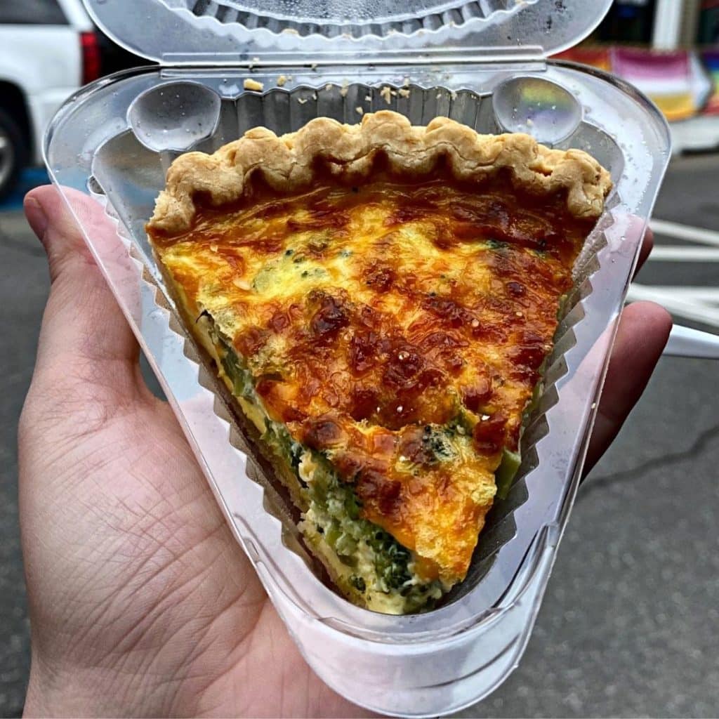 Closeup of Broccoli Cheddar Quiche in a to-go container.