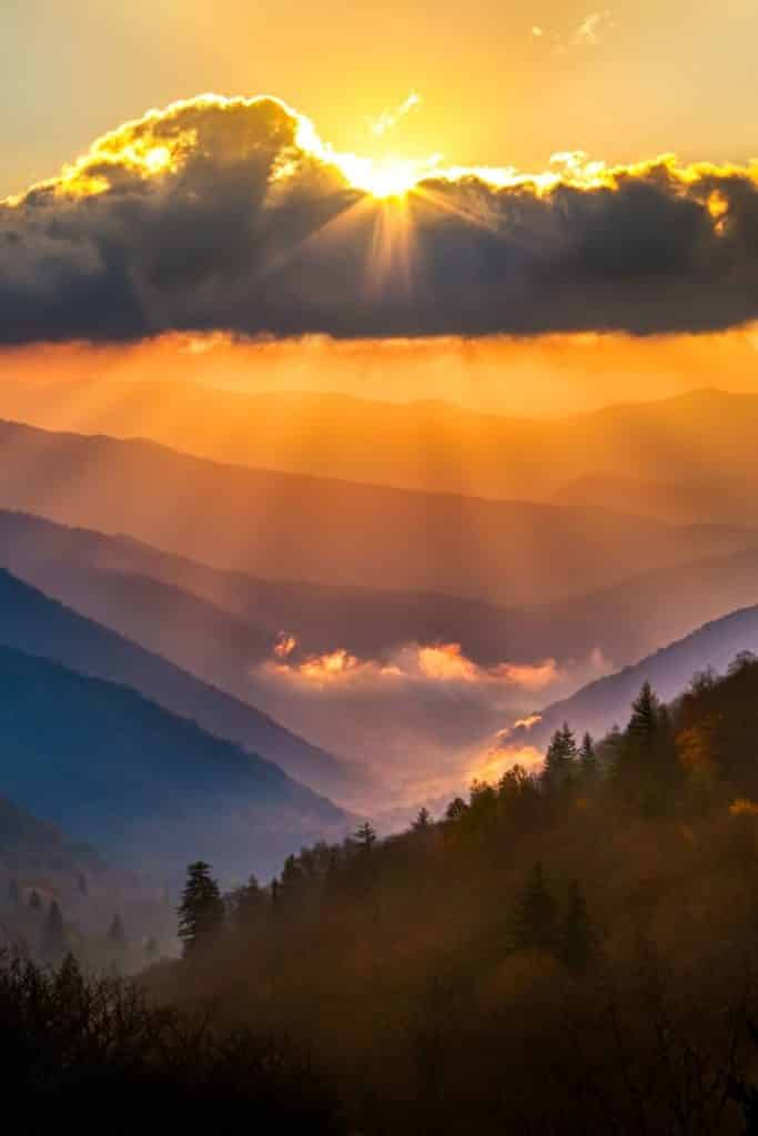 Photo of the Oconaluftee overlook in the Great Smoky Mountains during sunrise on a cloudy day.