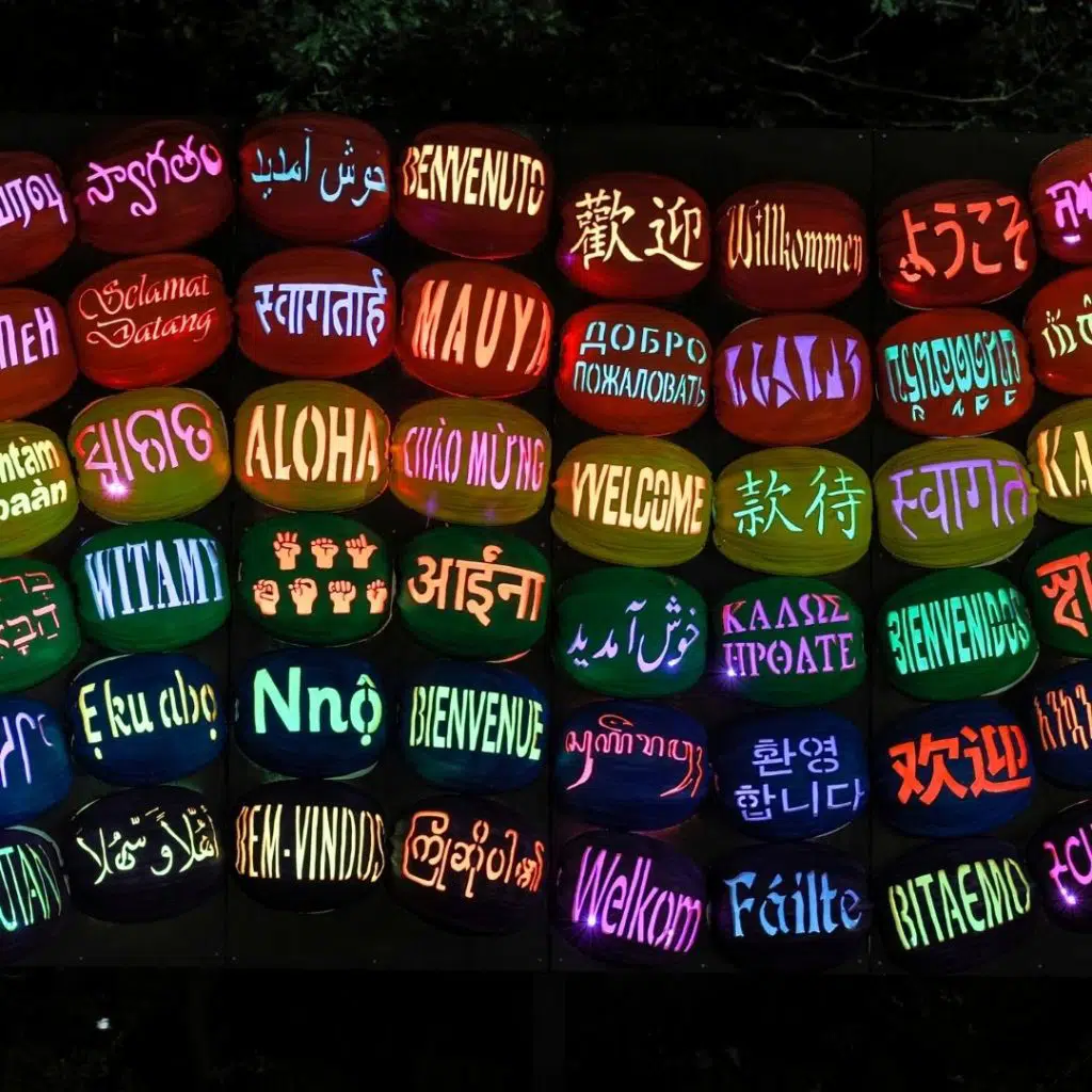 Photo of pumpkins carved with the word 'Welcome' in different languages.