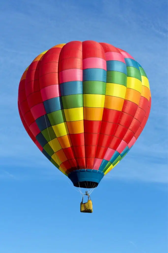 Photo of a colorful hot air balloon in the air.