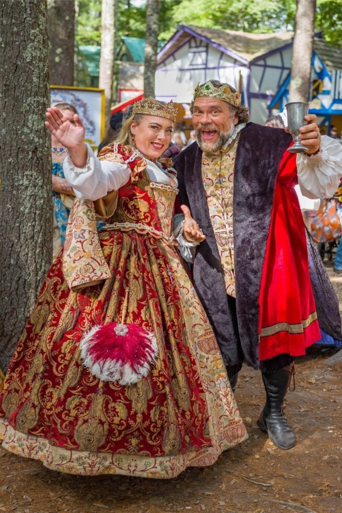 Photo of a man and a woman dressed in opulent Renaissance garb at King Richard's Faire in Massachusetts.