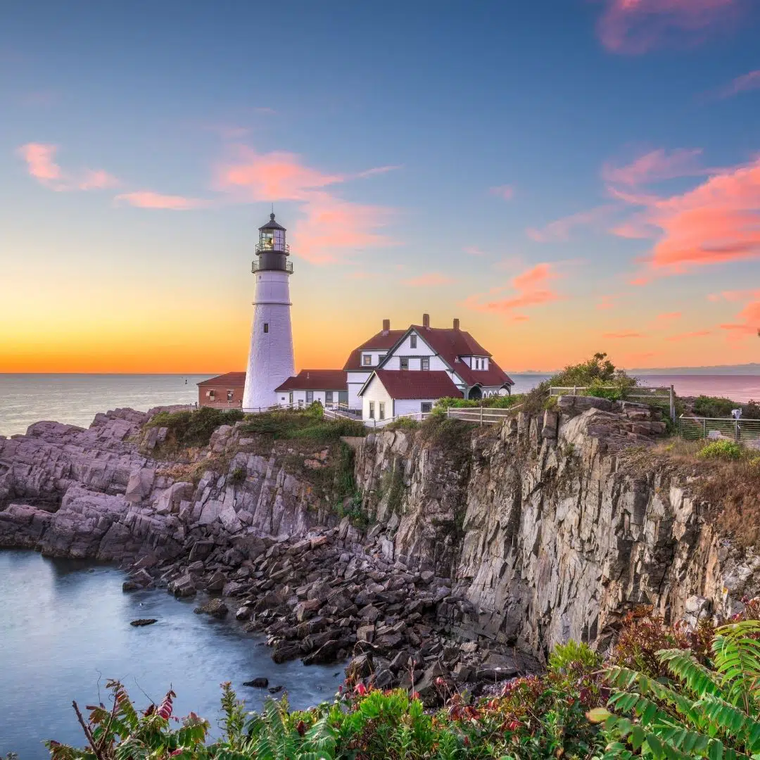 Photo of a lighthouse on a cliff in Portland during sunset.