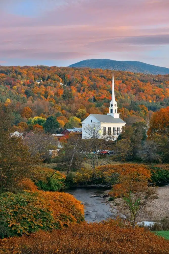 Aerial photo of the iconic white church in Stowe Vermont surrounded by Fall colors.