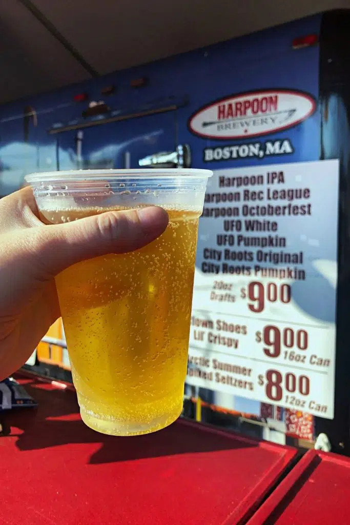 Closeup of a cup of hard pumpkin cider from Harpoon Brewery booth at The Big E.