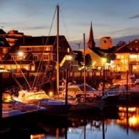 Photo of the Salem waterfront with boats docked at night.