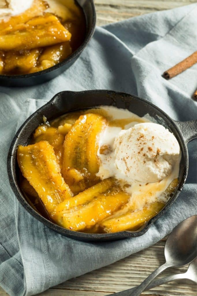 Photo of a small skillet with bananas foster sundae.