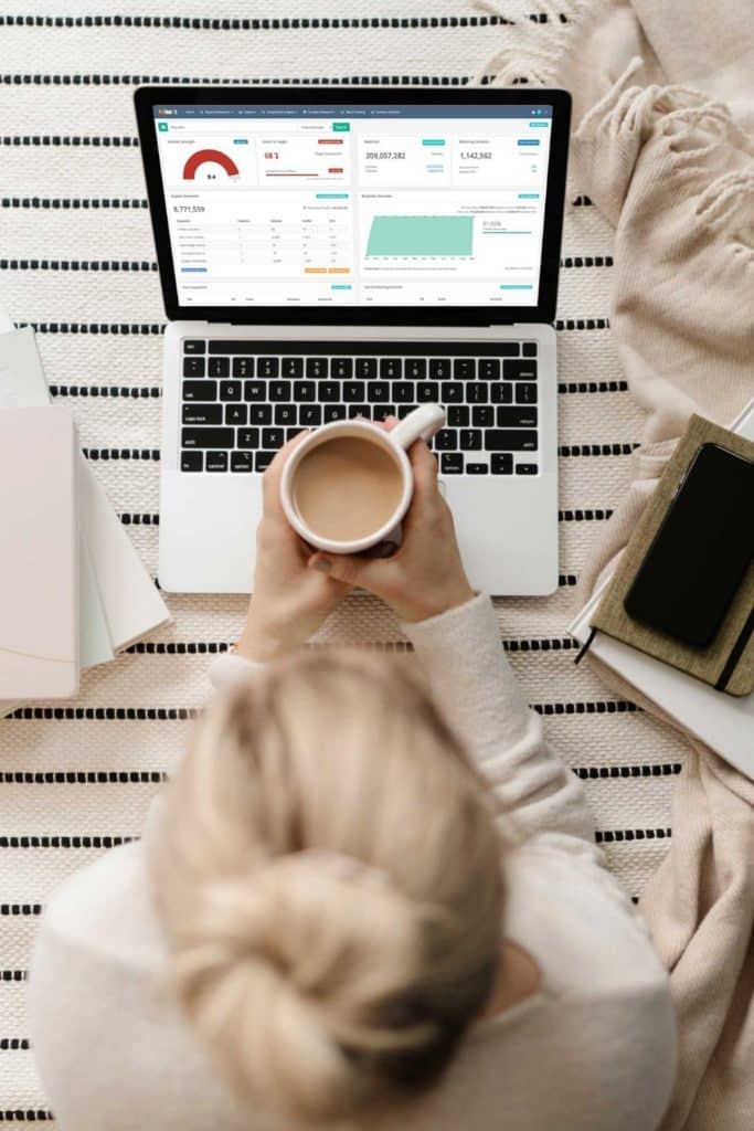 Photo of a woman looking at a laptop open to a SEO checker tool.