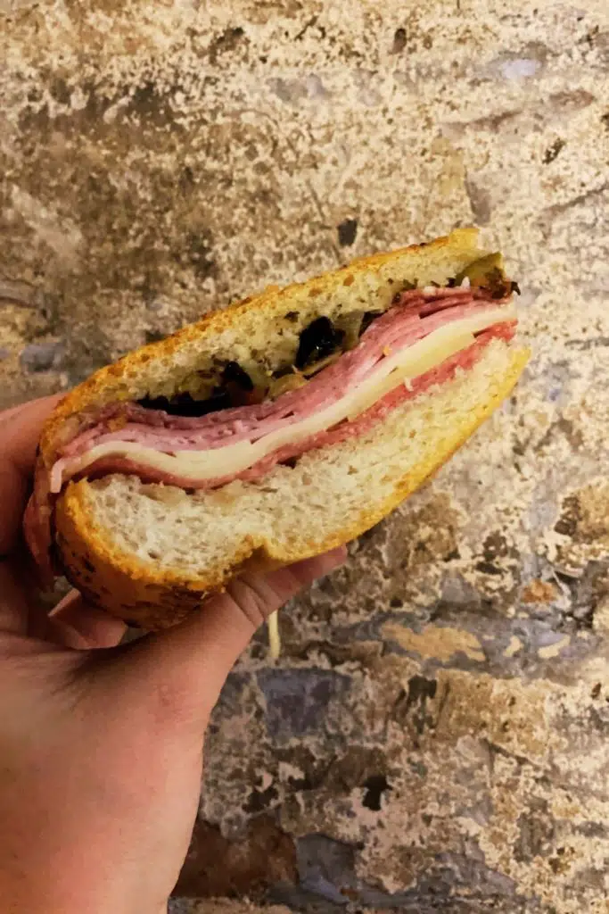 Closeup of a muffuletta sandwich from central grocery in New Orleans' French Quarter.
