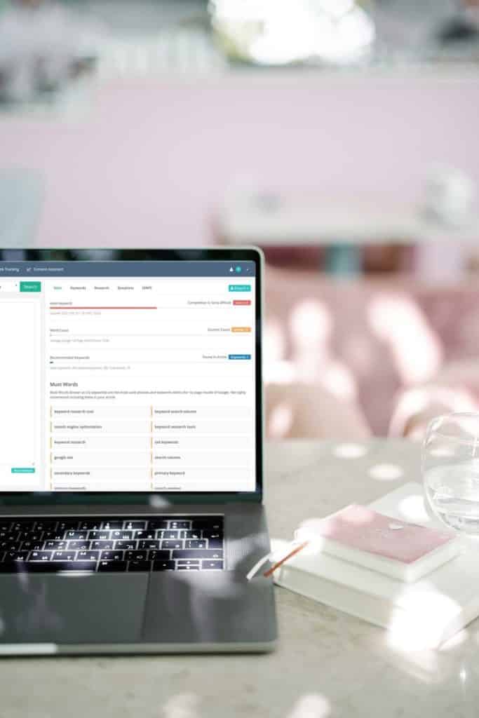 Photo of a laptop open to the Keysearch Content Assistant SEO tool.
