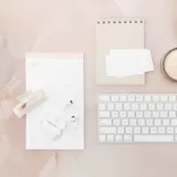 Photo of a pink and white bloggers desk.