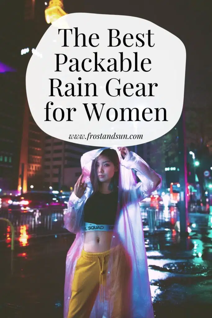 Photo of woman standing on a city sidewalk with a clear rain jacket on. Text above her reads "The Best Packable Rain Gear for Women."