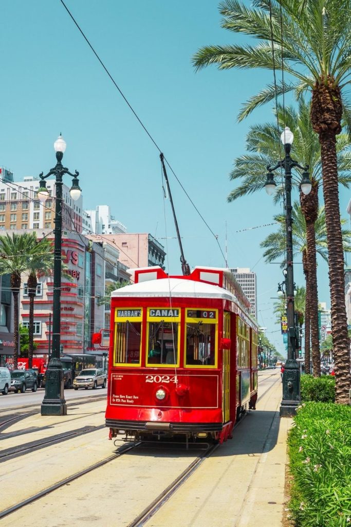 Photo of a red Canal Street streetcar in New Orleans.