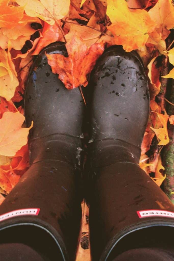 Top-down photo of a woman wearing black Hunter packable rain boots.