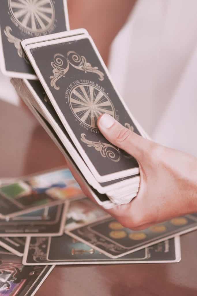 Closeup of a person shuffling a deck of tarot cards.