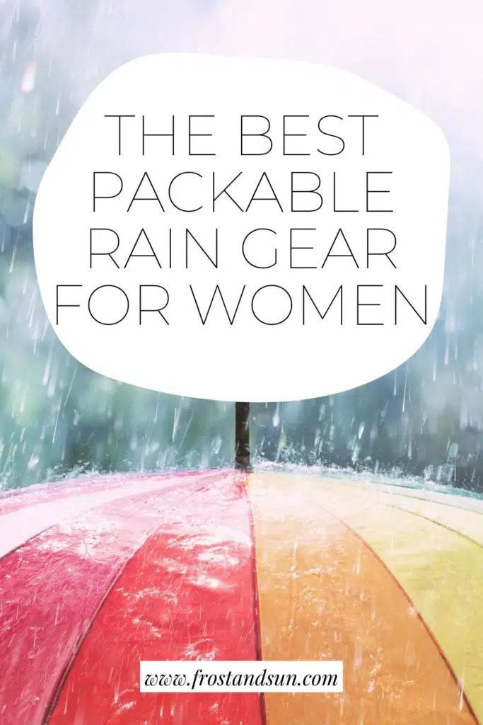 Closeup of the top of a rainbow colored umbrella with rain falling on it. Text above the photo reads "The Best Packable Rain Gear for Women."