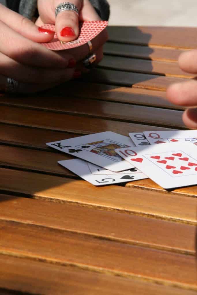 Closeup of people playing cards.