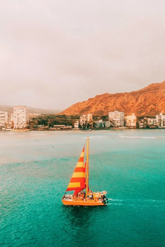 Photo of Na Hoku II cocktail sunset cruise with Waikiki in the background.