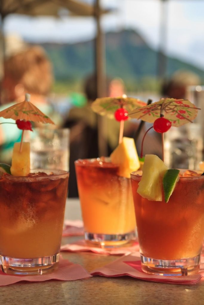 Closeup photo of mai tai cocktails at an outdoor bar.