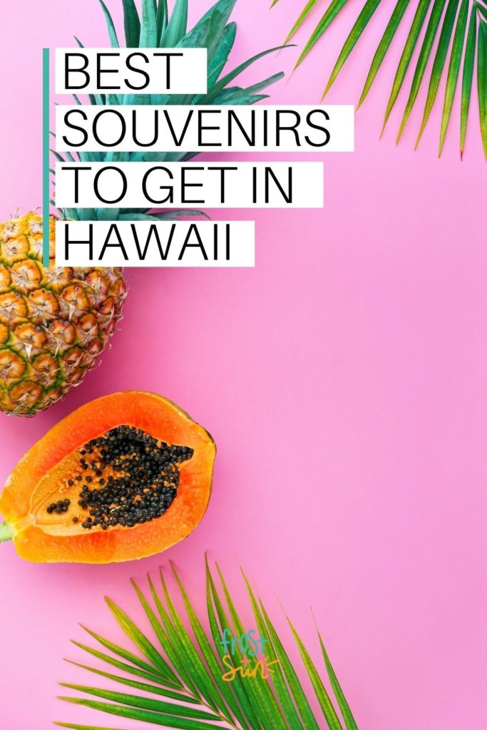 Photo of a pineapple, papaya and palm fronds on a pink background. Text across the top reads "Best Souvenirs to Get in Hawaii."