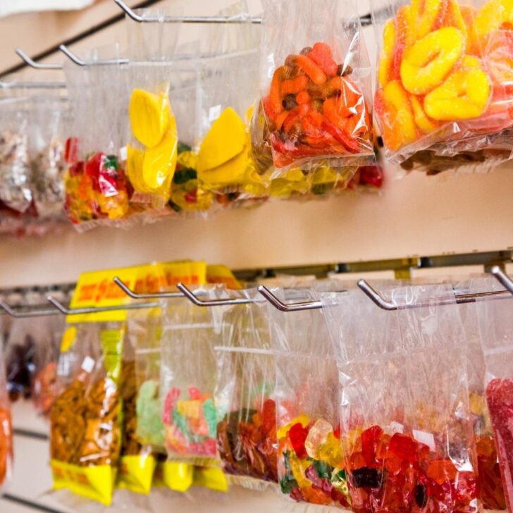 Closeup of bags filled with candy and dried fruit dipped in li hing mui powder.