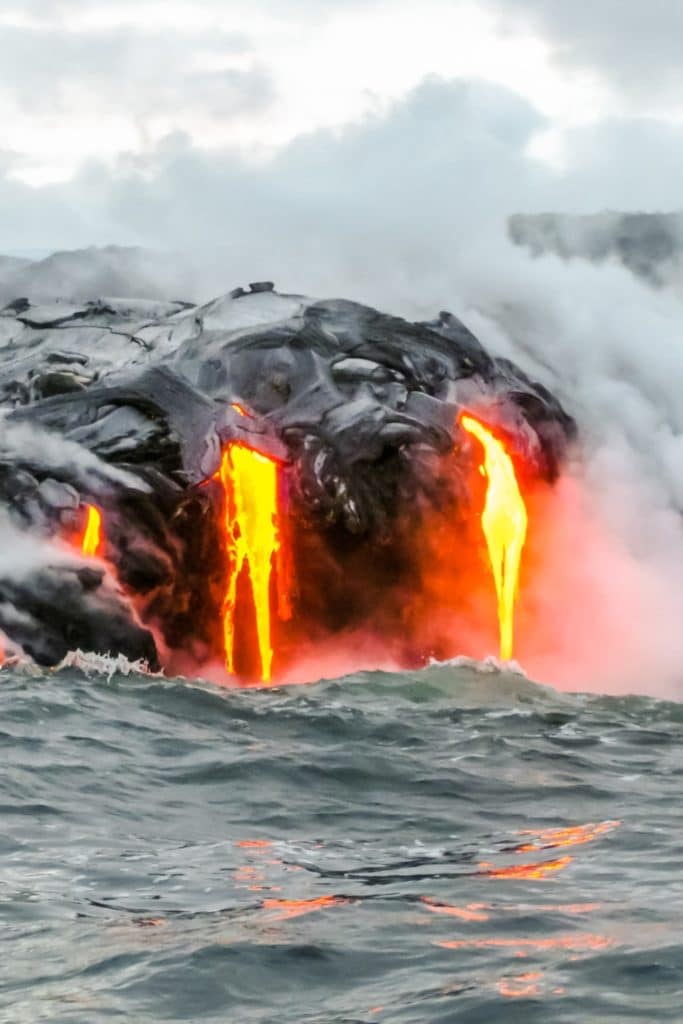 Photo of lava flowing into the ocean from Kilauea volcano.