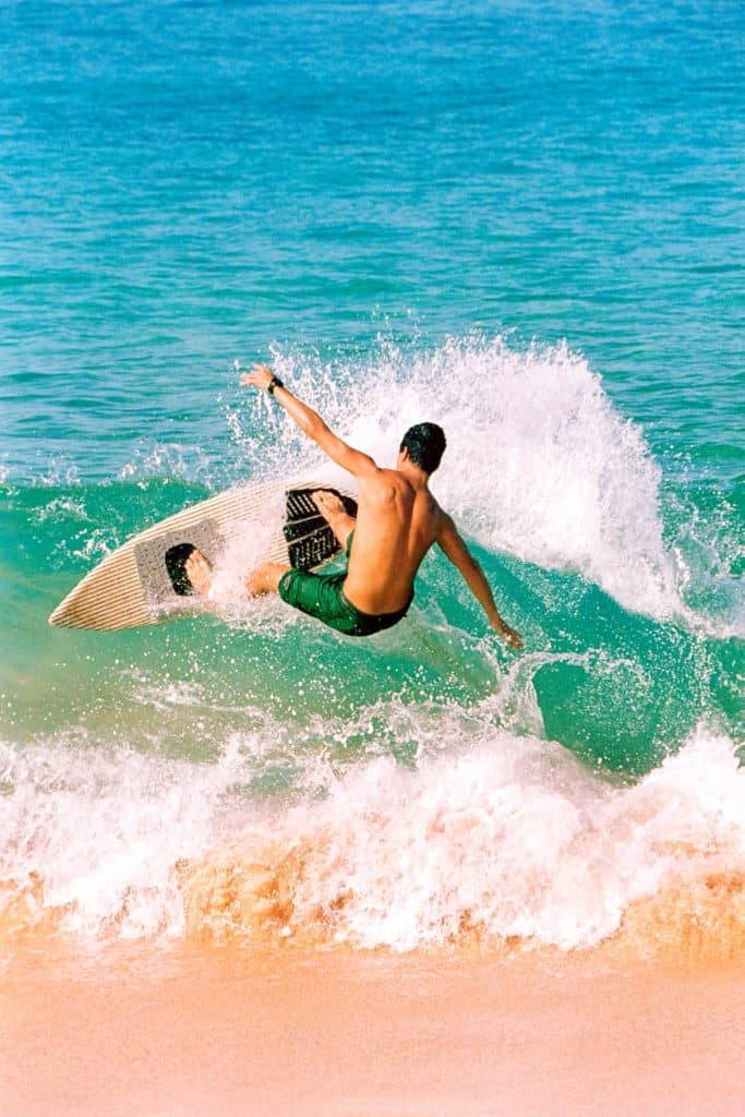 Photo of a man surfing in the ocean.