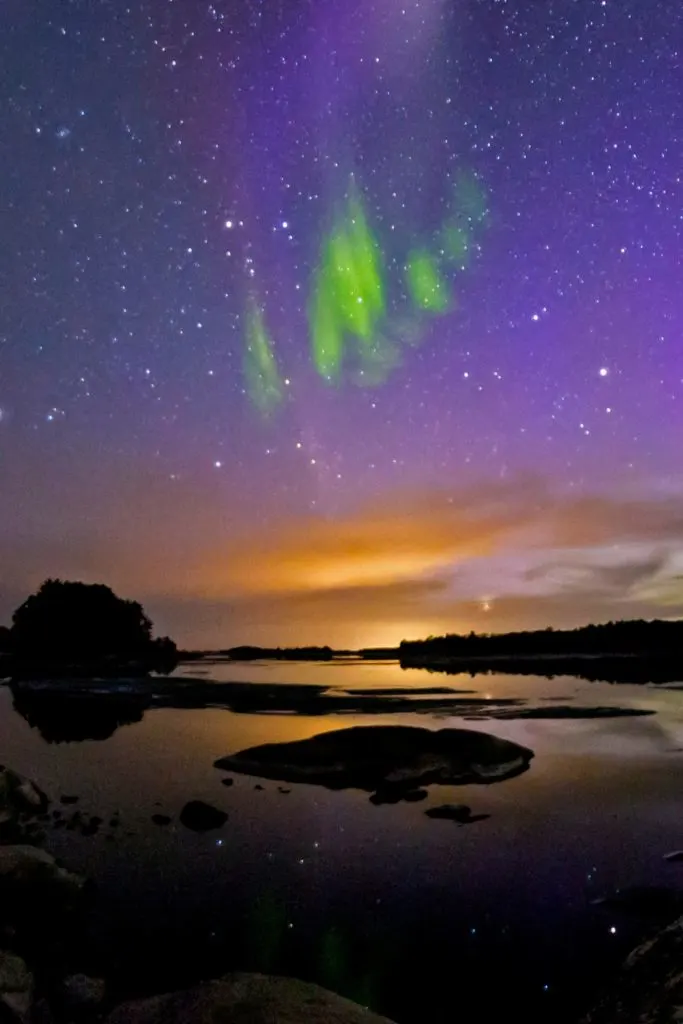 Photo of the Northern Lights above a lake at Voyageurs National Park in Minnesota.