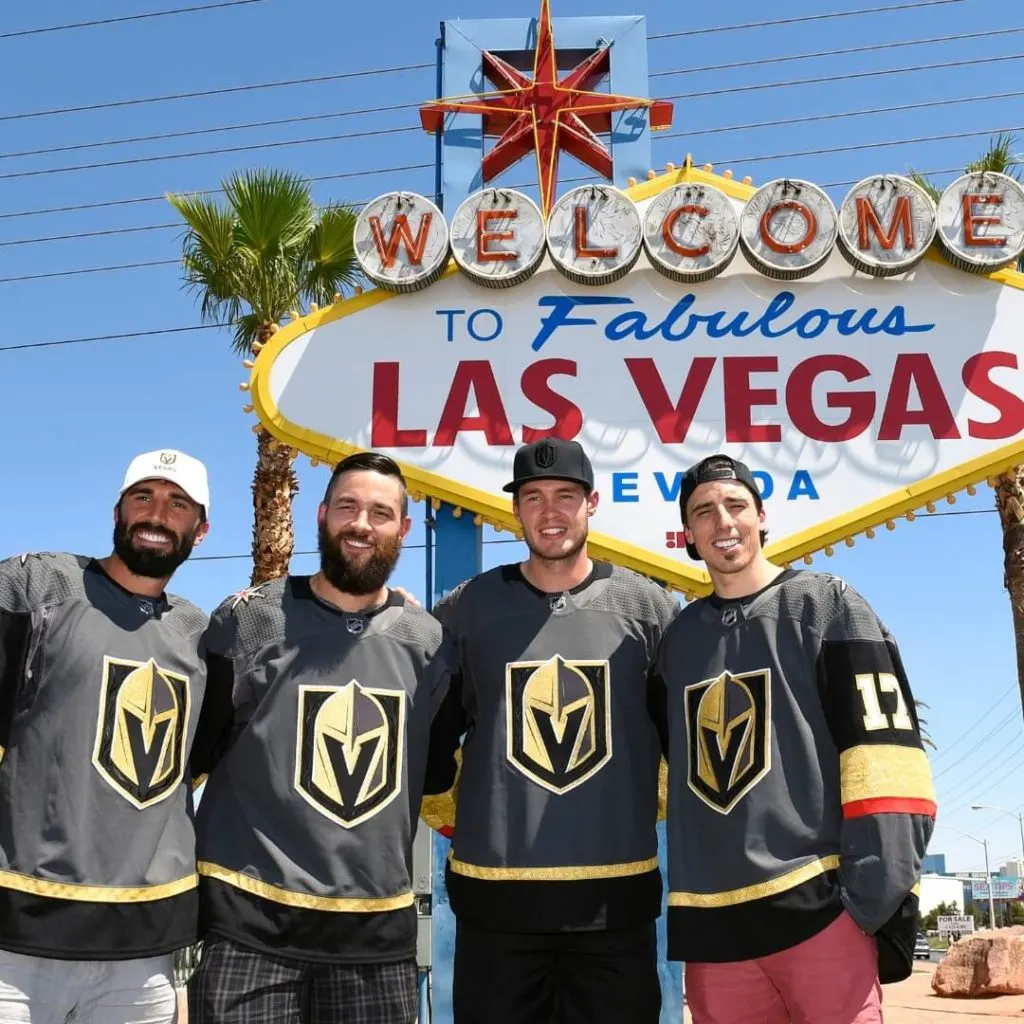 Photo of Vegas Golden Knights players (left to right) Jason Garrison, Deryk Engelland, Brayden McNabb and Marc-Andre Fleury posing in front of the Welcome to Fabulous Las Vegas sign.