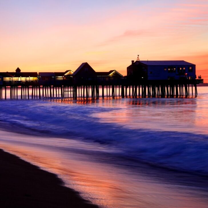 Photo of Old Orchard Beach, Maine during sunrise with the boardwalk in the background.
