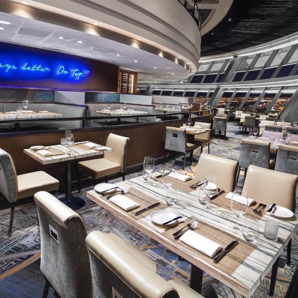 Photo of the interior of the Stratosphere restaurant overlooking Las Vegas at night.