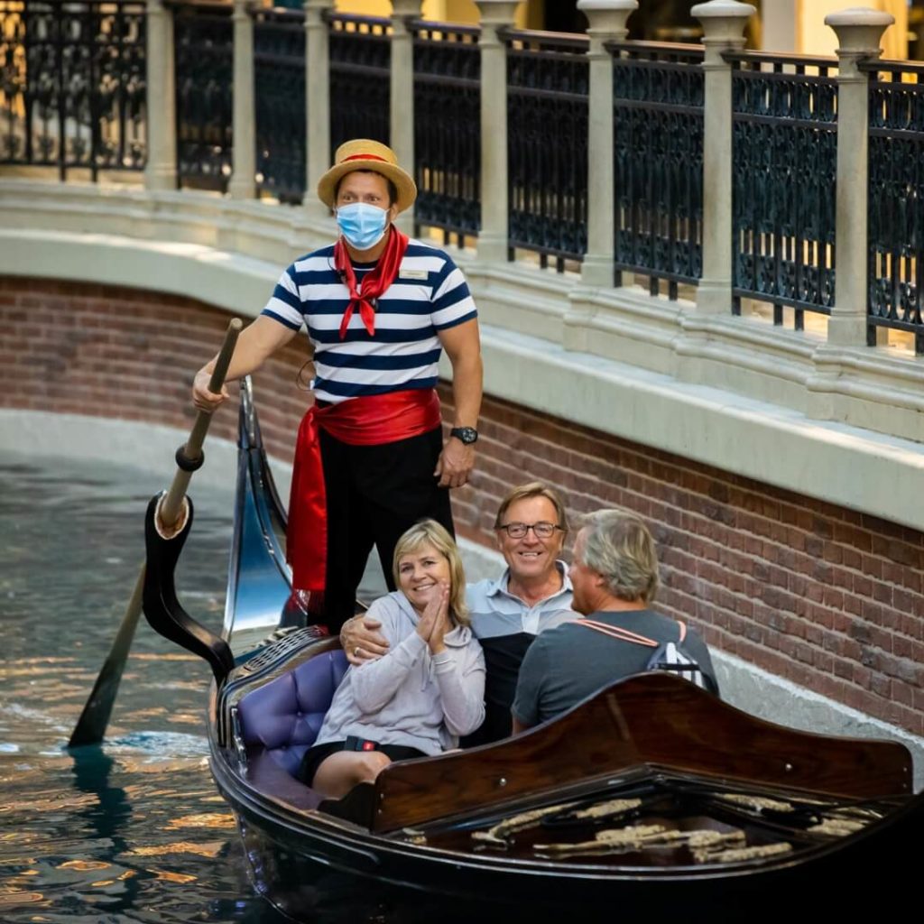 Photo of 3 adults riding in a gondola at the Venetian Resort in Vegas.