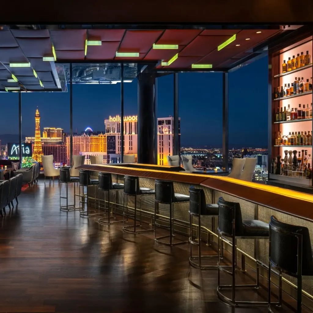 Photo of the interior of Waldorf Astoria Vegas' SkyBar overlooking the Las Vegas strip at night.